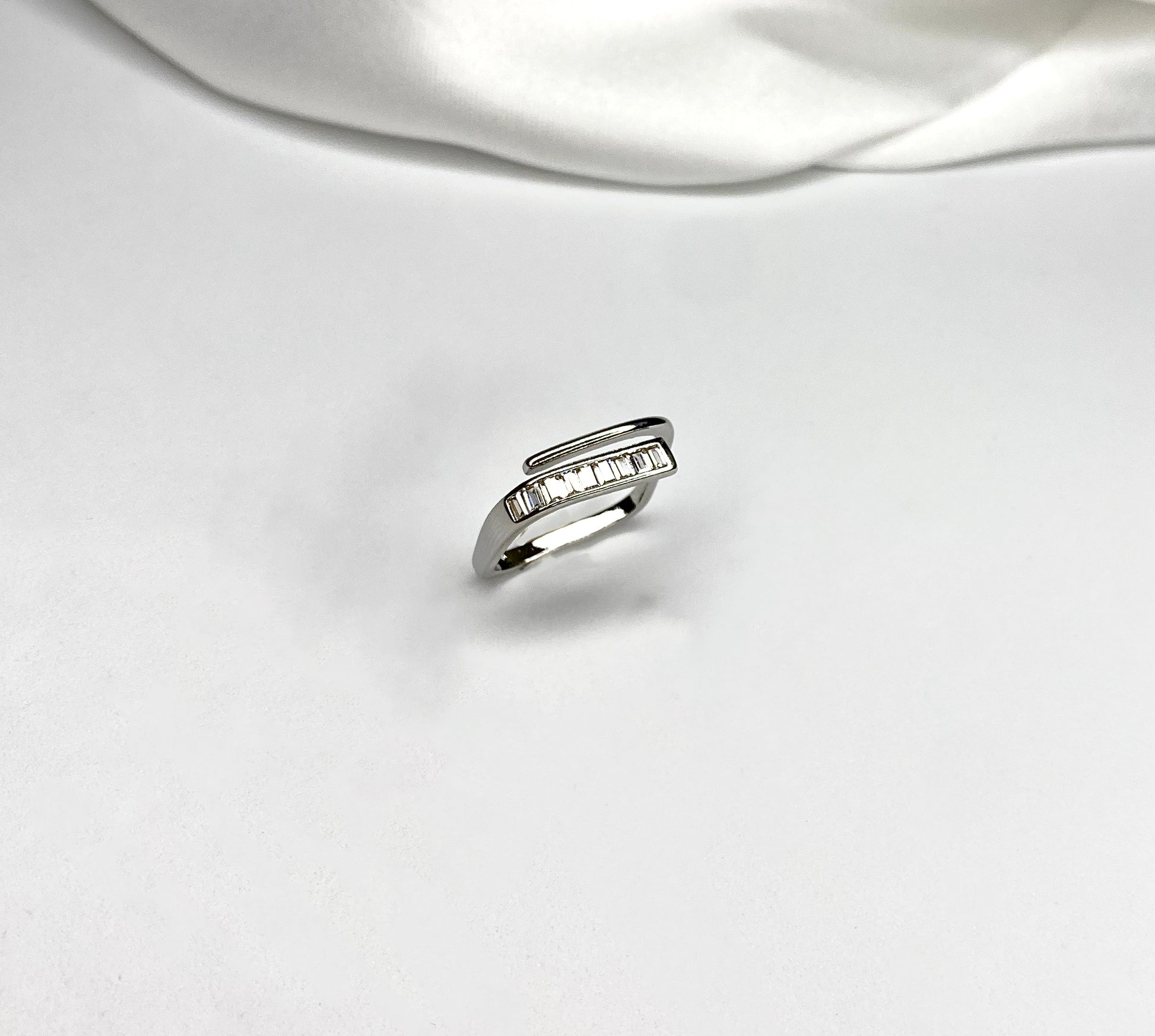 Anello CarrèAnello dalla forma squadrata con doppio incrocio semplice e con zirconcini incastonati. Regolabile. In acciaio inossidabile, disponibile anche placcato in oro 14k, aAnello CarrèAnelli